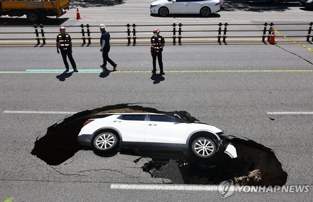 2.5-meter deep sinkhole swallows car in Seoul, injuring 2